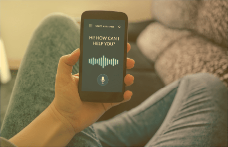 Hand holding cell phone while digital assistant asks how are you