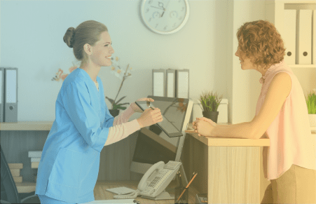 blue to orange gradient of a front desk healthcare worker talking to a patient