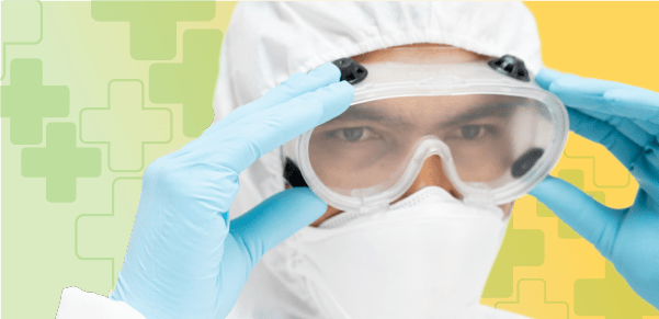 Lab worker wearing personal protective equipment, goggles, and gloves