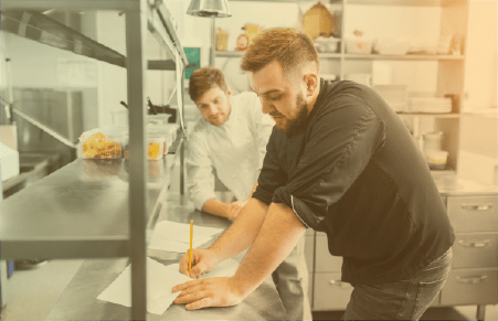 Chef and sous chef in the kitchen planning menu