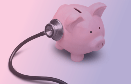 pink piggy bank with stethoscope 