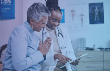 Patient and doctor pleasantly discussing results on clipboard