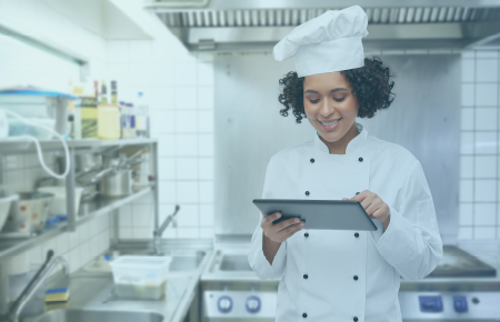 Chef in kitchen with a tablet