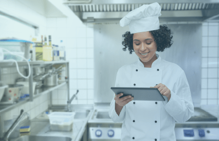 Chef in kitchen with a tablet