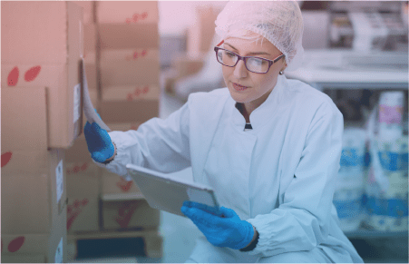 woman in PPE checking incoming shipment of products