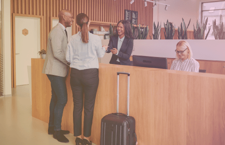 Happy couple checking in to hotel