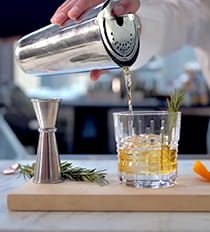 Bartender pouring a mocktail from a shaker