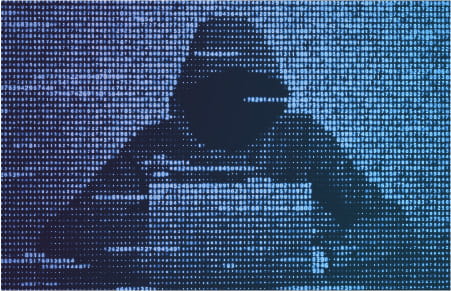 Hooded figure on laptop