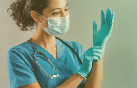 nurse putting on an exam glove
