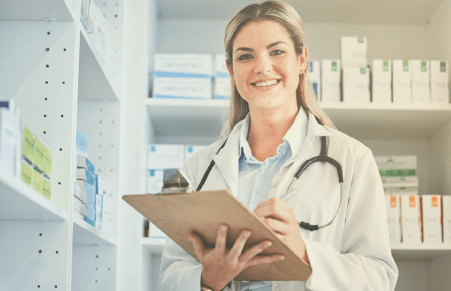 Pharmacist in pharmacy holding clip board