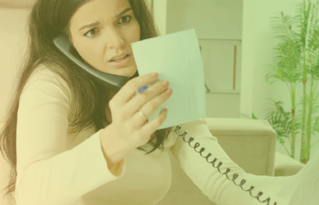 Concerned woman on the phone holding a bill