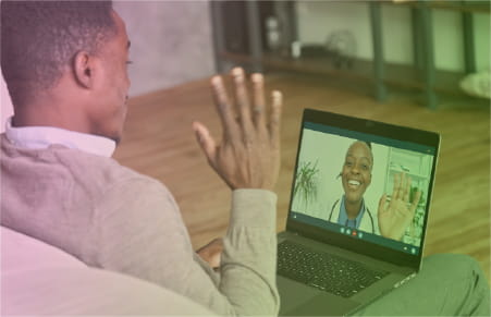 patient waving to doctor on laptop using telehealth
