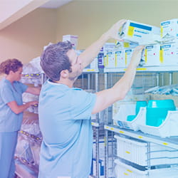 Pharmacy techs restocking supplies on shelf